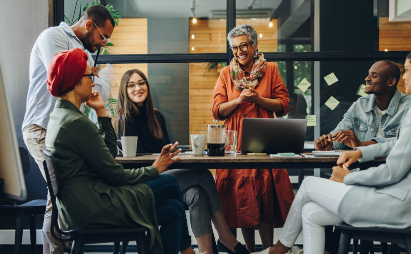 6 people around a meeting desk