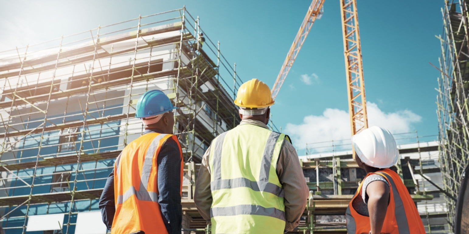 Workmen on a building site, outside on a sunny day