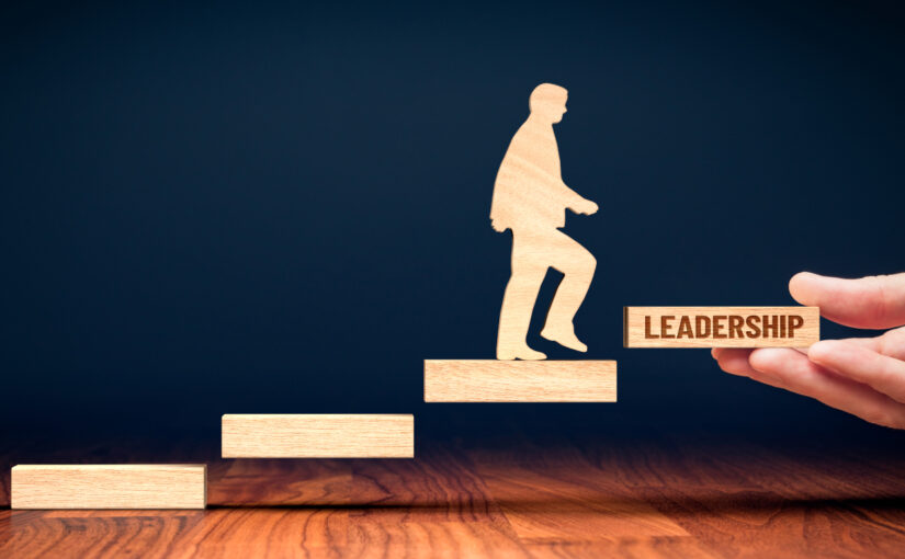 cut out figure of a professional climbing the career ladder to become a leader